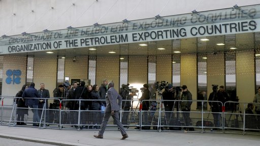 (AP Photo/Ronald Zak). People stand in front of the headquarters of the Organization of the Petroleum Exporting Countries, OPEC, in Vienna, Austria, Wednesday, Dec. 5, 2018. (AP Photo/Ronald Zak). People stand in front of the headquarters of the Organization of the Petroleum Exporting Countries, OPEC, in Vienna, Austria, Wednesday, Dec. 5, 2018.