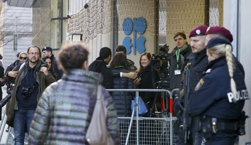 (AP Photo/Ronald Zak). People stand in front of the headquarters of the Organization of the Petroleum Exporting Countries, OPEC, in Vienna, Austria, Wednesday, Dec.5, 2018. (AP Photo/Ronald Zak). People stand in front of the headquarters of the Organization of the Petroleum Exporting Countries, OPEC, in Vienna, Austria, Wednesday, Dec.5, 2018.
