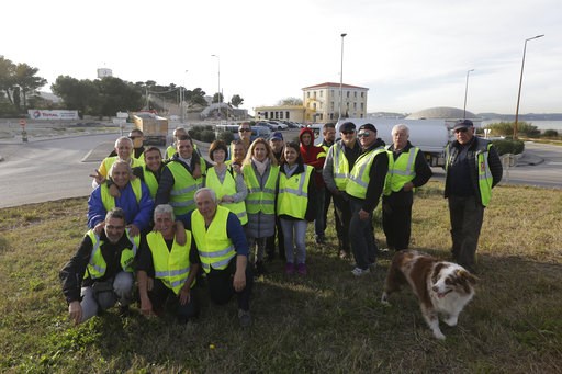 (AP Photo/Claude Paris). A group of demonstrators wearing their yellow vest pose on an occupied traffic circle, Wednesday, Dec. 5, 2018 outside La Mede oil refinery, near Martigues, southeastern France. Trade unions and farmers pledged Wednesday to joi... (AP Photo/Claude Paris). A group of demonstrators wearing their yellow vest pose on an occupied traffic circle, Wednesday, Dec. 5, 2018 outside La Mede oil refinery, near Martigues, southeastern France. Trade unions and farmers pledged Wednesday to joi...