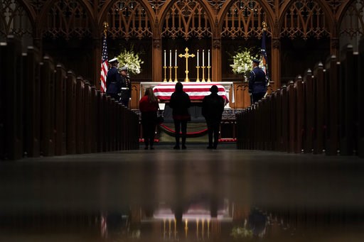 (AP Photo/David J. Phillip, Pool). People pay their respects as former President George H.W. Bush lies in repose at St. Martin's Episcopal Church Wednesday, Dec. 5, 2018, in Houston. (AP Photo/David J. Phillip, Pool). People pay their respects as former President George H.W. Bush lies in repose at St. Martin's Episcopal Church Wednesday, Dec. 5, 2018, in Houston.
