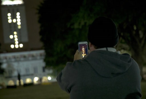 (Nick Wagner/Austin American-Statesman via AP). A man uses his phone to photograph the University of Texas at Austin tower as it is lit "41" in honor of former President George H.W. Bush on Wednesday, Dec. 5, 2018, in Austin, Texas. The nation bid good... (Nick Wagner/Austin American-Statesman via AP). A man uses his phone to photograph the University of Texas at Austin tower as it is lit "41" in honor of former President George H.W. Bush on Wednesday, Dec. 5, 2018, in Austin, Texas. The nation bid good...