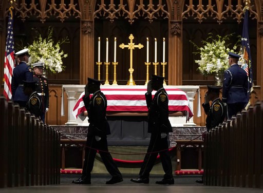 (AP Photo/David J. Phillip, Pool). Military members salute as they pay their respects as former President George H.W. Bush lies in repose at St. Martin's Episcopal Church Wednesday, Dec. 5, 2018, in Houston. (AP Photo/David J. Phillip, Pool). Military members salute as they pay their respects as former President George H.W. Bush lies in repose at St. Martin's Episcopal Church Wednesday, Dec. 5, 2018, in Houston.