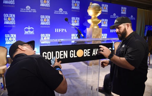 (Photo by Chris Pizzello/Invision/AP). John Langhammer, left, and Brian Cooper, of Crews Unlimited II, set up the podium prior to the announcements of the nominations for the 76th Annual Golden Globe Awards at the Beverly Hilton hotel on Thursday, Dec.... (Photo by Chris Pizzello/Invision/AP). John Langhammer, left, and Brian Cooper, of Crews Unlimited II, set up the podium prior to the announcements of the nominations for the 76th Annual Golden Globe Awards at the Beverly Hilton hotel on Thursday, Dec....
