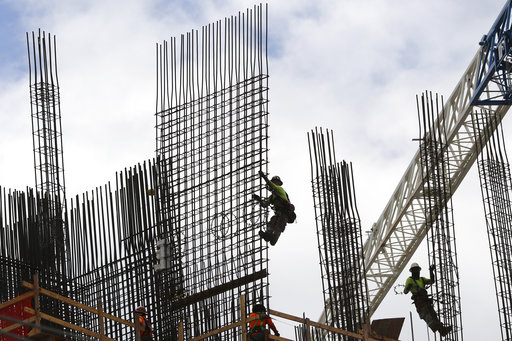 (Amy Beth Bennett/South Florida Sun-Sentinel via AP, File). FILE- In this Sept. 24, 2018, photo metal workers are silhouetted on the top of The Rise, a luxury apartment building under construction in Flagler Village in downtown Fort Lauderdale, Fla. On... (Amy Beth Bennett/South Florida Sun-Sentinel via AP, File). FILE- In this Sept. 24, 2018, photo metal workers are silhouetted on the top of The Rise, a luxury apartment building under construction in Flagler Village in downtown Fort Lauderdale, Fla. On...