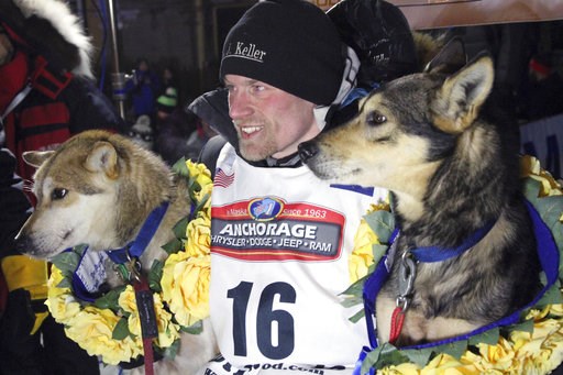 (AP Photo/Mark Thiessen, File). FILE - In this March 15, 2016, file photo, Dallas Seavey poses with his lead dogs Reef, left, and Tide after finishing the Iditarod Trail Sled Dog Race in Nome, Alaska. Iditarod officials have cleared a four-time champio...