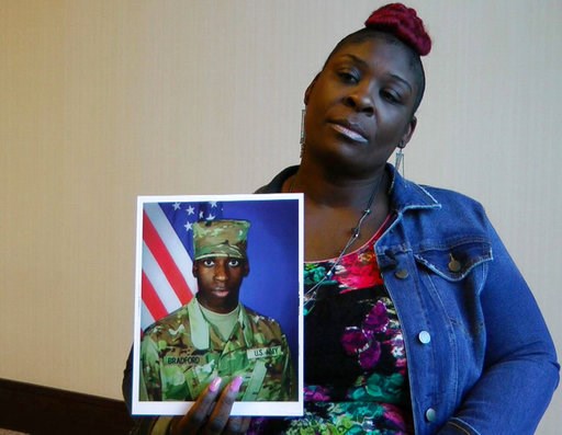 (AP Photo/Jay Reeves, File). FILE - In this Nov. 27, 2018, file frame from video, April Pipkins holds a photograph of her deceased son, Emantic "EJ" Bradford Jr., during an interview in Birmingham, Ala. Bradford, who was licensed to carry a gun, was ki... (AP Photo/Jay Reeves, File). FILE - In this Nov. 27, 2018, file frame from video, April Pipkins holds a photograph of her deceased son, Emantic "EJ" Bradford Jr., during an interview in Birmingham, Ala. Bradford, who was licensed to carry a gun, was ki...