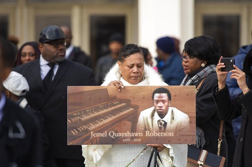 (Tyler LaRiviere/Chicago Sun-Times via AP, File). FILE - In this Nov. 8, 2018, file photo, a woman holds up a sign with Jemel Roberson's image at his funeral in Chicago. Roberson, who was working security at a bar, was killed on Nov. 11 while holding a... (Tyler LaRiviere/Chicago Sun-Times via AP, File). FILE - In this Nov. 8, 2018, file photo, a woman holds up a sign with Jemel Roberson's image at his funeral in Chicago. Roberson, who was working security at a bar, was killed on Nov. 11 while holding a...