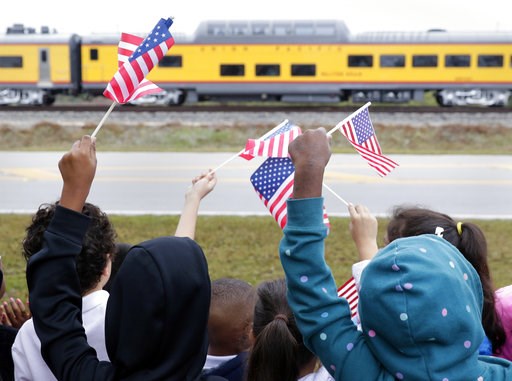 (AP Photo/Michael Wyke). Students from Salyer Elementary School wave flags as the train carrying the body of former president George H.W. Bush travels past their school on the way to Bush's final internment Thursday, Dec. 6, 2018, in Spring, Texas. (AP Photo/Michael Wyke). Students from Salyer Elementary School wave flags as the train carrying the body of former president George H.W. Bush travels past their school on the way to Bush's final internment Thursday, Dec. 6, 2018, in Spring, Texas.