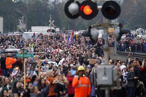 (AP Photo/David J. Phillip, Pool). People pay their respects as the train carrying the casket of former President George H.W. Bush passes Thursday, Dec. 6, 2018, along the route from Spring to College Station, Texas. (AP Photo/David J. Phillip, Pool). People pay their respects as the train carrying the casket of former President George H.W. Bush passes Thursday, Dec. 6, 2018, along the route from Spring to College Station, Texas.