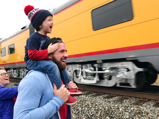 (AP Photo/Nomaan Merchant). Ryder Davis, 3, watches the memorial train for President George H.W. Bush pass through Pinehurst, Texas, atop the shoulders of his father, 27-year-old Matthew Davis, on Thursday, in Pinehurst, Texas. On Thursday, that same 4... (AP Photo/Nomaan Merchant). Ryder Davis, 3, watches the memorial train for President George H.W. Bush pass through Pinehurst, Texas, atop the shoulders of his father, 27-year-old Matthew Davis, on Thursday, in Pinehurst, Texas. On Thursday, that same 4...