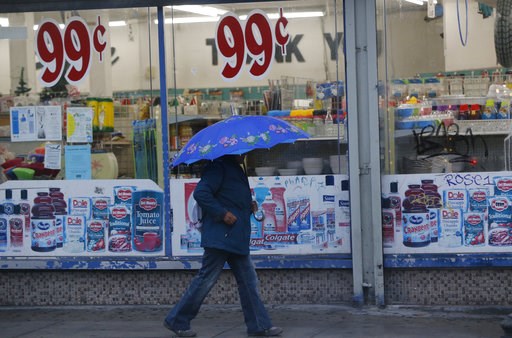(AP Photo/Damian Dovarganes). A pedestrian walks past a 99-Cents store under light rain in Los Angeles Wednesday, Dec. 5, 2018. A fall storm is causing slick conditions on Southern California freeways but isn't expected to generate enough rain to trigg... (AP Photo/Damian Dovarganes). A pedestrian walks past a 99-Cents store under light rain in Los Angeles Wednesday, Dec. 5, 2018. A fall storm is causing slick conditions on Southern California freeways but isn't expected to generate enough rain to trigg...