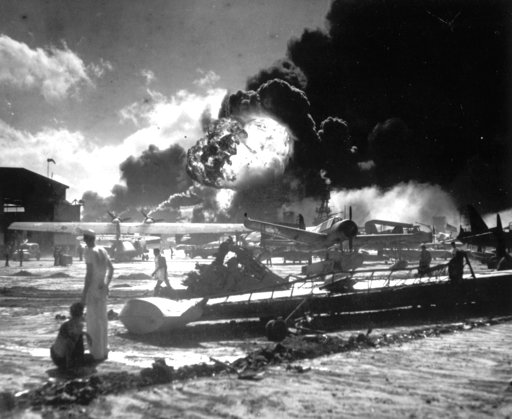 (U.S. Navy via AP, File). In this Dec. 7, 1941 file photo, sailors stand among wrecked airplanes at Ford Island Naval Air Station as they watch the explosion of the USS Shaw in the background, during the Japanese attack on Pearl Harbor, Hawaii. About 2... (U.S. Navy via AP, File). In this Dec. 7, 1941 file photo, sailors stand among wrecked airplanes at Ford Island Naval Air Station as they watch the explosion of the USS Shaw in the background, during the Japanese attack on Pearl Harbor, Hawaii. About 2...