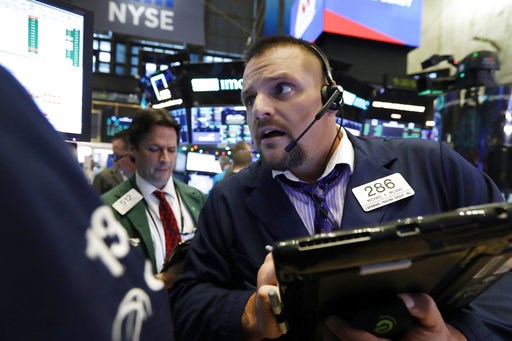(AP Photo/Richard Drew, File). FILE- In this Dec. 3, 2018, file photo trader Michael Milano, right, works on the floor of the New York Stock Exchange. The U.S. stock market opens at 9:30 a.m. EST on Friday, Dec. 7.