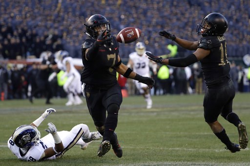 (AP Photo/Matt Slocum). Army's Jaylon McClinton, center, intercepts a pass tipped by teammate Mike Reynolds, right, that was intended for Navy's Mychal Cooper during the first half of an NCAA college football game, Saturday, Dec. 8, 2018, in Philadelph... (AP Photo/Matt Slocum). Army's Jaylon McClinton, center, intercepts a pass tipped by teammate Mike Reynolds, right, that was intended for Navy's Mychal Cooper during the first half of an NCAA college football game, Saturday, Dec. 8, 2018, in Philadelph...