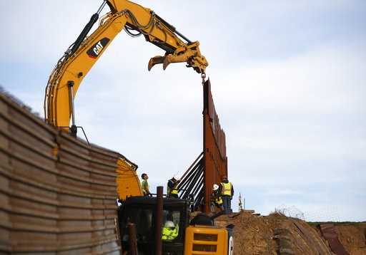 (AP Photo/Gregory Bull). Workers replace sections of the border wall, left, with new sections, right, Tuesday, Jan. 8, 2019, in Tijuana, Mexico. Ready to make his case on prime-time TV, President Donald Trump is stressing humanitarian as well as securi... (AP Photo/Gregory Bull). Workers replace sections of the border wall, left, with new sections, right, Tuesday, Jan. 8, 2019, in Tijuana, Mexico. Ready to make his case on prime-time TV, President Donald Trump is stressing humanitarian as well as securi...