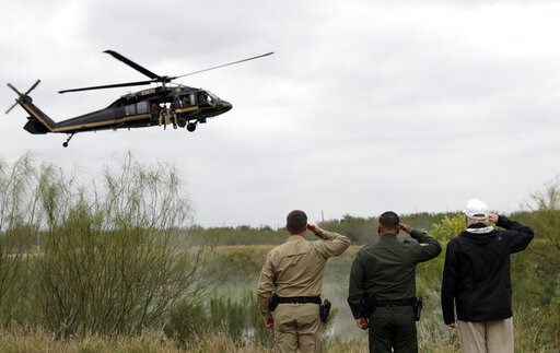 (AP Photo/ Evan Vucci). President Donald Trump salutes as a U.S. customs and Border Protection helicopter passes as he tours the U.S. border with Mexico at the Rio Grande on the southern border, Thursday, Jan. 10, 2019, in McAllen, Texas. (AP Photo/ Evan Vucci). President Donald Trump salutes as a U.S. customs and Border Protection helicopter passes as he tours the U.S. border with Mexico at the Rio Grande on the southern border, Thursday, Jan. 10, 2019, in McAllen, Texas.