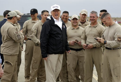 (AP Photo/ Evan Vucci). President Donald Trump turns as he talks to U.S. Customs and Border Protection officers at McAllen International Airport as he prepares to leave after a visit to the southern border, Thursday, Jan. 10, 2019, in McAllen, Texas. (AP Photo/ Evan Vucci). President Donald Trump turns as he talks to U.S. Customs and Border Protection officers at McAllen International Airport as he prepares to leave after a visit to the southern border, Thursday, Jan. 10, 2019, in McAllen, Texas.