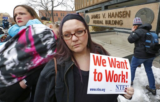 (AP Photo/Rick Bowmer). IRS worker Christine Helquist joins a federal workers protest rally outside the Federal Building, Thursday, Jan., 10, 2019, in Ogden, Utah. Payday will come Friday without any checks for about 800,000 federal employees affected ... (AP Photo/Rick Bowmer). IRS worker Christine Helquist joins a federal workers protest rally outside the Federal Building, Thursday, Jan., 10, 2019, in Ogden, Utah. Payday will come Friday without any checks for about 800,000 federal employees affected ...