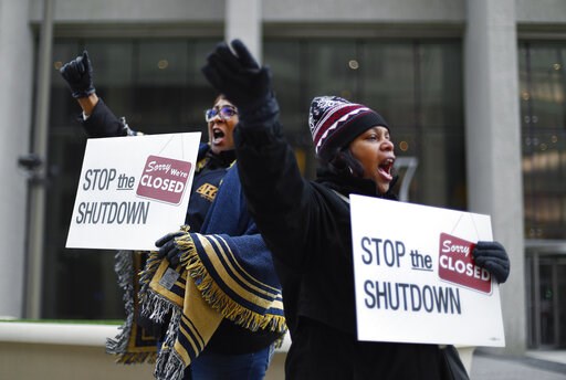 (AP Photo/Paul Sancya). Cheryl Monroe, right, a Food and Drug Administration employee, and Bertrice Sanders, a Social Security Administration employee, rally to call for an end to the partial government shutdown in Detroit, Thursday, Jan. 10, 2019. (AP Photo/Paul Sancya). Cheryl Monroe, right, a Food and Drug Administration employee, and Bertrice Sanders, a Social Security Administration employee, rally to call for an end to the partial government shutdown in Detroit, Thursday, Jan. 10, 2019.