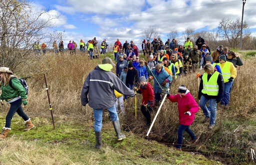 (AP Photo/Jeff Baenen, File). FILE - In this Oct. 23, 2018, file photo, volunteers cross a creek and barbed wire near Barron, Wis., on their way to a ground search for 13-year-old Jayme Closs who was discovered missing Oct. 15 after her parents were fo... (AP Photo/Jeff Baenen, File). FILE - In this Oct. 23, 2018, file photo, volunteers cross a creek and barbed wire near Barron, Wis., on their way to a ground search for 13-year-old Jayme Closs who was discovered missing Oct. 15 after her parents were fo...