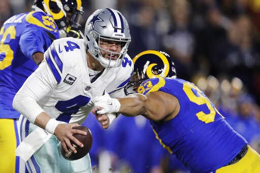 (AP Photo/Jae C. Hong). Dallas Cowboys quarterback Dak Prescott breaks away from Los Angeles Rams nose tackle Ndamukong Suh during the first half in an NFL divisional football playoff game Saturday, Jan. 12, 2019, in Los Angeles. (AP Photo/Jae C. Hong). Dallas Cowboys quarterback Dak Prescott breaks away from Los Angeles Rams nose tackle Ndamukong Suh during the first half in an NFL divisional football playoff game Saturday, Jan. 12, 2019, in Los Angeles.