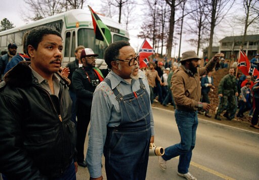 (AP Photo/Gene Blythe). FILE -In this Jan. 18, 1987, photo, Atlanta city councilman, Rev. Hosea Williams, in overalls, leads a march against efforts to keep Forsyth County in Georgia all white past counter-protesters near Cumming, Ga., as a crowd waves... (AP Photo/Gene Blythe). FILE -In this Jan. 18, 1987, photo, Atlanta city councilman, Rev. Hosea Williams, in overalls, leads a march against efforts to keep Forsyth County in Georgia all white past counter-protesters near Cumming, Ga., as a crowd waves...