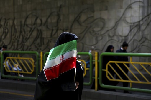 (AP Photo/Ebrahim Noroozi, File). FILE - In this Feb. 11, 2016 file photograph, an Iranian woman holds the national flag during a rally commemorating the 37th anniversary of the Islamic revolution, in Tehran, Iran. Iran's 1979 Islamic Revolution initia... (AP Photo/Ebrahim Noroozi, File). FILE - In this Feb. 11, 2016 file photograph, an Iranian woman holds the national flag during a rally commemorating the 37th anniversary of the Islamic revolution, in Tehran, Iran. Iran's 1979 Islamic Revolution initia...