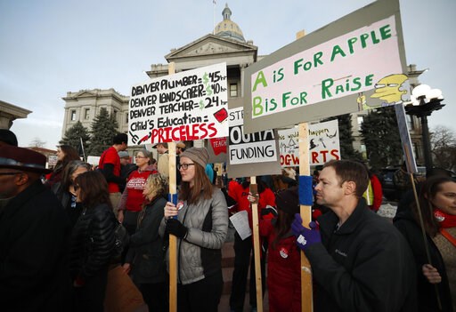 (AP Photo/David Zalubowski, File). FILE - In this Wednesday, Jan. 30, 2019, file photo, teachers from the Denver Public Schools carry placards as they wait to march after a rally in support of a strike outside the State Capitol in Denver. Denver teache... (AP Photo/David Zalubowski, File). FILE - In this Wednesday, Jan. 30, 2019, file photo, teachers from the Denver Public Schools carry placards as they wait to march after a rally in support of a strike outside the State Capitol in Denver. Denver teache...