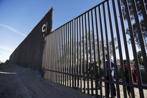 (AP Photo/Gregory Bull, File). FILE - In this March 5, 2018, file photo, boys look through an older section of the border structure from Mexicali, Mexico, alongside a newly-constructed, taller section, left, in Calexico, Calif. A federal appeals court ... (AP Photo/Gregory Bull, File). FILE - In this March 5, 2018, file photo, boys look through an older section of the border structure from Mexicali, Mexico, alongside a newly-constructed, taller section, left, in Calexico, Calif. A federal appeals court ...