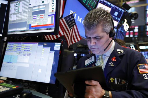 Asian shares mostly lower as investors watch trade talks