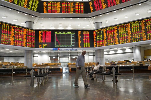 Asian shares mostly lower as investors watch trade talks