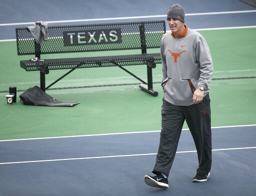 (Ralph Barrera/Austin American-Statesman via AP). In this January 2018 photo, Texas men’s tennis coach Michael Center surveys the courts before the matches with UTSA, in Austin, Texas. Center is among a few people in the state charged in a scheme that ... (Ralph Barrera/Austin American-Statesman via AP). In this January 2018 photo, Texas men’s tennis coach Michael Center surveys the courts before the matches with UTSA, in Austin, Texas. Center is among a few people in the state charged in a scheme that ...