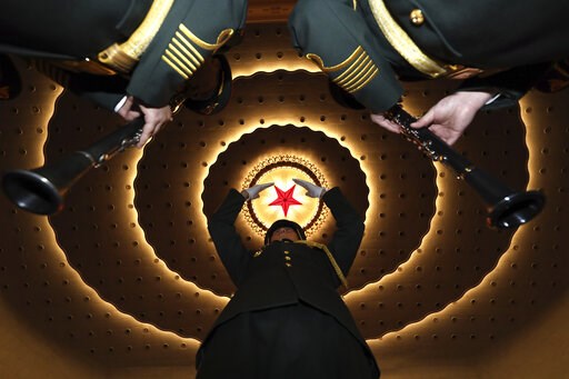 (AP Photo/Ng Han Guan). A military band conductor rehearses the band before the closing session of the National People's Congress in Beijing's Great Hall of the People on Friday, March 15, 2019.