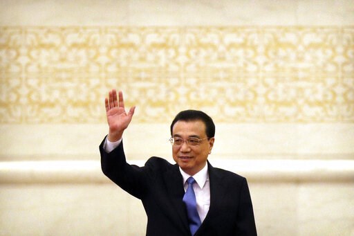 (AP Photo/Mark Schiefelbein). Chinese Premier Li Keqiang waves as he arrives for a press conference held after the closing session of China's National People's Congress (NPC) at the Great Hall of the People in Beijing, Friday, March 15, 2019. (AP Photo/Mark Schiefelbein). Chinese Premier Li Keqiang waves as he arrives for a press conference held after the closing session of China's National People's Congress (NPC) at the Great Hall of the People in Beijing, Friday, March 15, 2019.