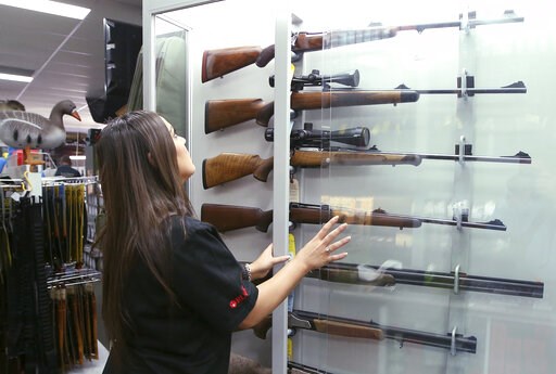 (AP Photo/Rick Rycroft). FILE - In this Wednesday, Oct. 4, 2017 file photo, a salesperson checks rifles in a gun shop display in Sydney, Australia. A documentary aired in March 2019 by Al Jazeera reported officials with Australia's far-right One Nation... (AP Photo/Rick Rycroft). FILE - In this Wednesday, Oct. 4, 2017 file photo, a salesperson checks rifles in a gun shop display in Sydney, Australia. A documentary aired in March 2019 by Al Jazeera reported officials with Australia's far-right One Nation...