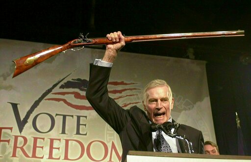 (AP Photo/Jim Cole, File). FILE - In this Oct. 21, 2002 file photo, National Rifle Association President Charlton Heston holds up a rifle as he addresses gun owners during a "get-out-the-vote" rally in Manchester, N.H. While American gun-rights are ens... (AP Photo/Jim Cole, File). FILE - In this Oct. 21, 2002 file photo, National Rifle Association President Charlton Heston holds up a rifle as he addresses gun owners during a "get-out-the-vote" rally in Manchester, N.H. While American gun-rights are ens...