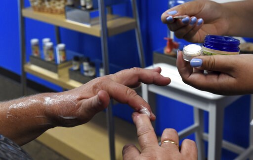 (Jean Pieri/Pioneer Press via AP, File). FILE - In this Aug. 29, 2018, file photo, a customer tries a free sample of a pain cream that contains cannabidiol (CBD) for her arthritis at Minnesota Hempdropz in Maplewood, Minn. Mainstream retailers are leap... (Jean Pieri/Pioneer Press via AP, File). FILE - In this Aug. 29, 2018, file photo, a customer tries a free sample of a pain cream that contains cannabidiol (CBD) for her arthritis at Minnesota Hempdropz in Maplewood, Minn. Mainstream retailers are leap...