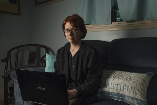 (AP Photo/Craig Hudson). In this Friday, April 5, 2019, photo, Kelly Povroznik poses for a portrait inside the living room of her home in Weston, W.Va. Povroznik teaches an online college course that has been hampered by slow connections on her compute... (AP Photo/Craig Hudson). In this Friday, April 5, 2019, photo, Kelly Povroznik poses for a portrait inside the living room of her home in Weston, W.Va. Povroznik teaches an online college course that has been hampered by slow connections on her compute...