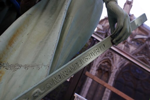 (AP Photo/Francois Mori). Detail of the religious statue representing St. Thomas in reference to French architect Eugene Viollet Le Duc perched atop Paris' Notre Dame Cathedral is loaded on a truck as part of a restoration, in Paris Thursday, April 11,... (AP Photo/Francois Mori). Detail of the religious statue representing St. Thomas in reference to French architect Eugene Viollet Le Duc perched atop Paris' Notre Dame Cathedral is loaded on a truck as part of a restoration, in Paris Thursday, April 11,...