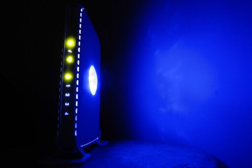 (AP Photo/Matt Rourke, File). FILE- This July 27, 2008, file photo shows a, LED-illuminated wireless router in Philadelphia. Officials from the United States and Europe are announcing charges against 10 people in connection with malicious software atta...