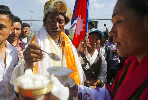 Nepal's record-setting Everest guide returns hero