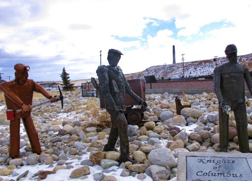 (AP Photo/Matt Volz, File). FILE - This Dec. 13, 2016, file photo, shows the former Anaconda smelter smokestack behind sculptures of miners at the Anaconda Smelter Stack State Park viewing area in Anaconda, Montana. Residents in the nearby community of...