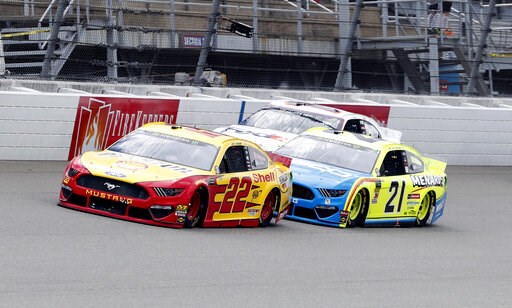 The Latest: Logano edges Kurt Busch, Truex in overtime