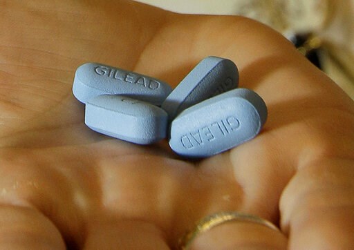 (AP Photo/Jeff Chiu, File). FILE - In this May 10, 2012, file photo, a doctor holds Truvada pills in her office in San Francisco. Studies released on Tuesday, June 11, 2019 show the anti-AIDS treatment also cuts the chances that someone who’s still hea...