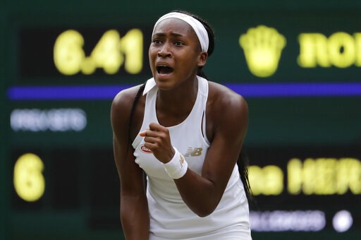 (AP Photo/Ben Curtis). United States' Cori "Coco" Gauff reacts after winning a point against Slovenia's Polona Hercog in a Women's singles match during day five of the Wimbledon Tennis Championships in London, Friday, July 5, 2019.
