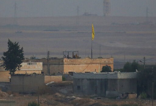 (AP Photo/Lefteris Pitarakis). In this photo taken from the Turkish side of the border between Turkey and Syria, in Akcakale, Sanliurfa province, southeastern Turkey, members of the Kurdish People's Protection Units, or YPG, hold a position on a buildi... (AP Photo/Lefteris Pitarakis). In this photo taken from the Turkish side of the border between Turkey and Syria, in Akcakale, Sanliurfa province, southeastern Turkey, members of the Kurdish People's Protection Units, or YPG, hold a position on a buildi...